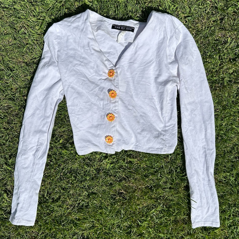 white top with flower buttons
